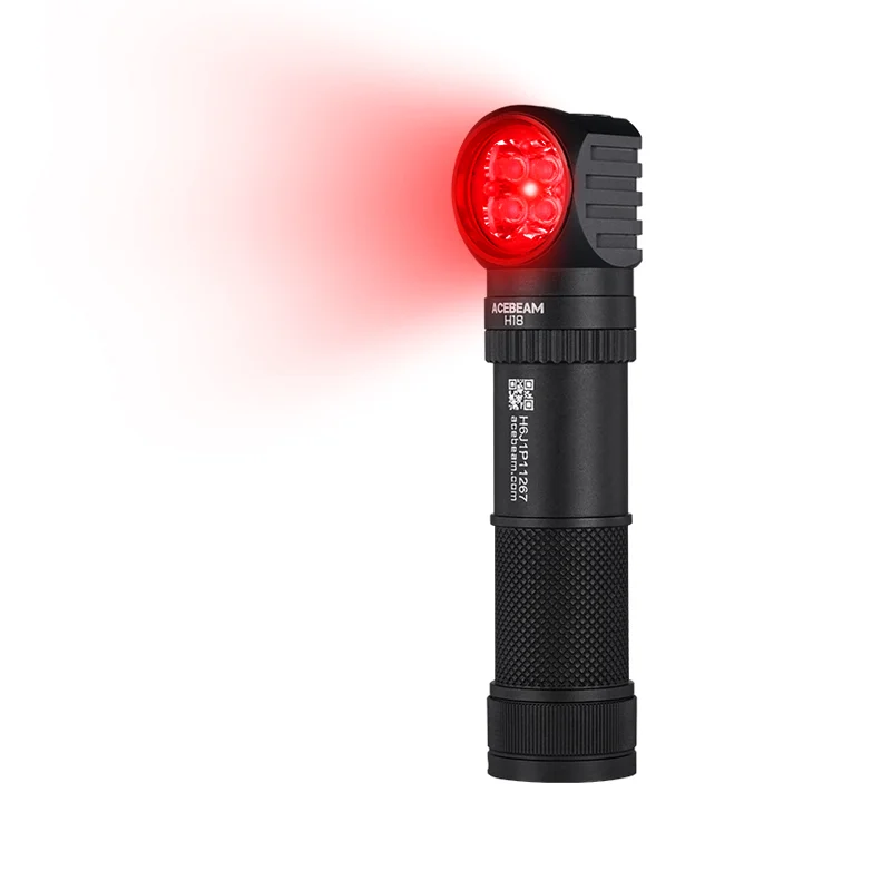 Black tactical flashlight with a red LED head emitting a red beam in the foreground.