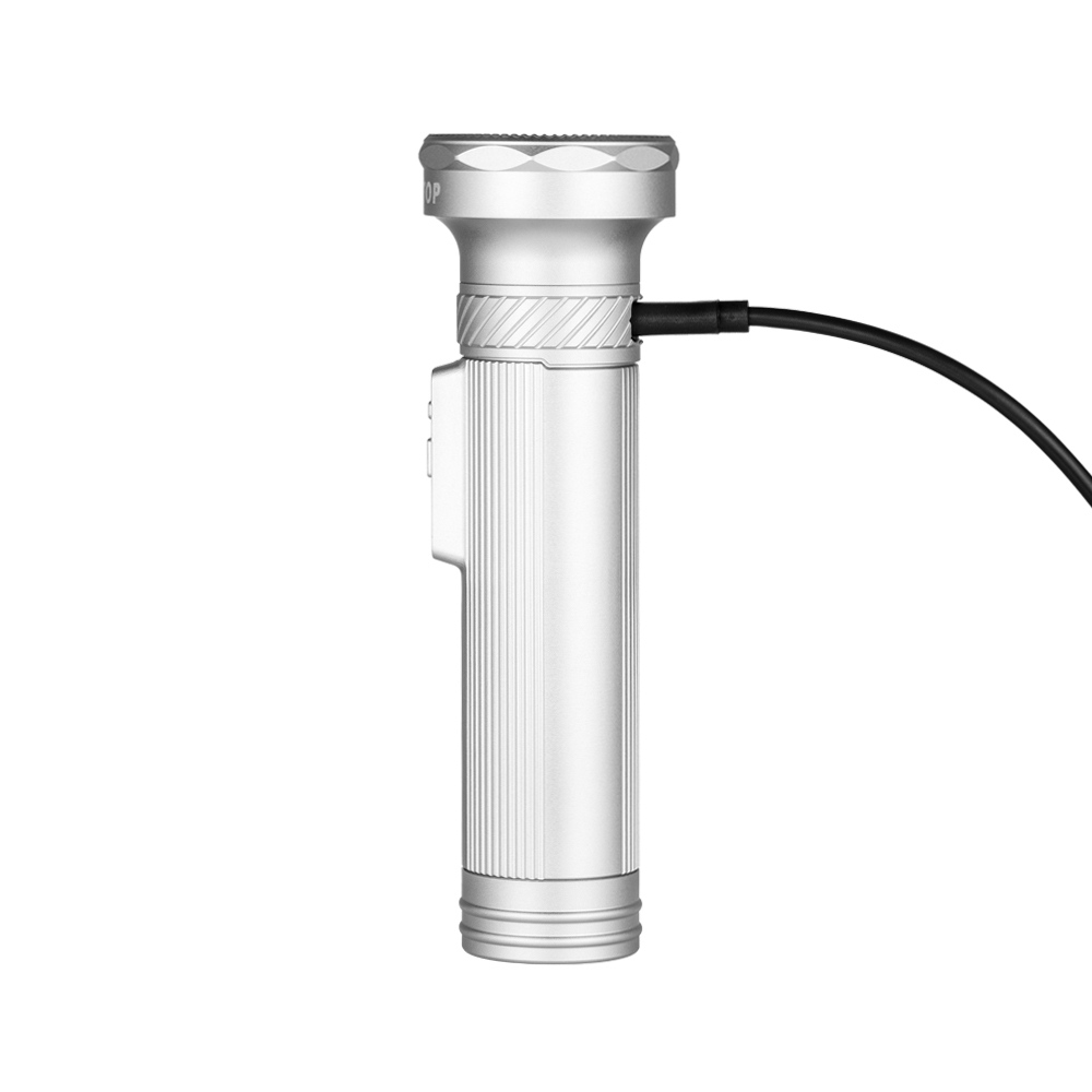 Silver handheld flashlight with ribbed grip and a black charging cable connected to the side.
